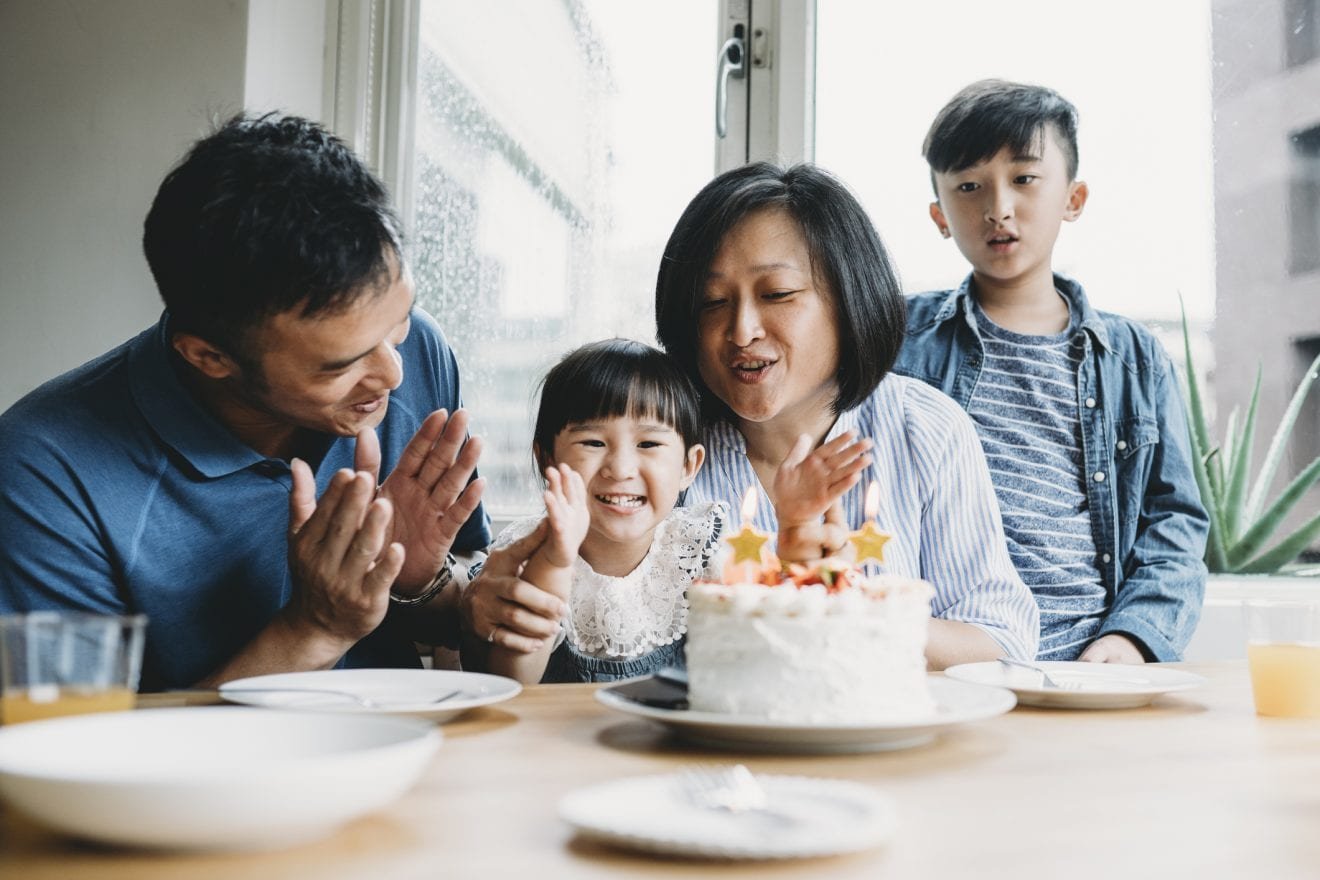 Family celebrating the birthday of the little daughter together.