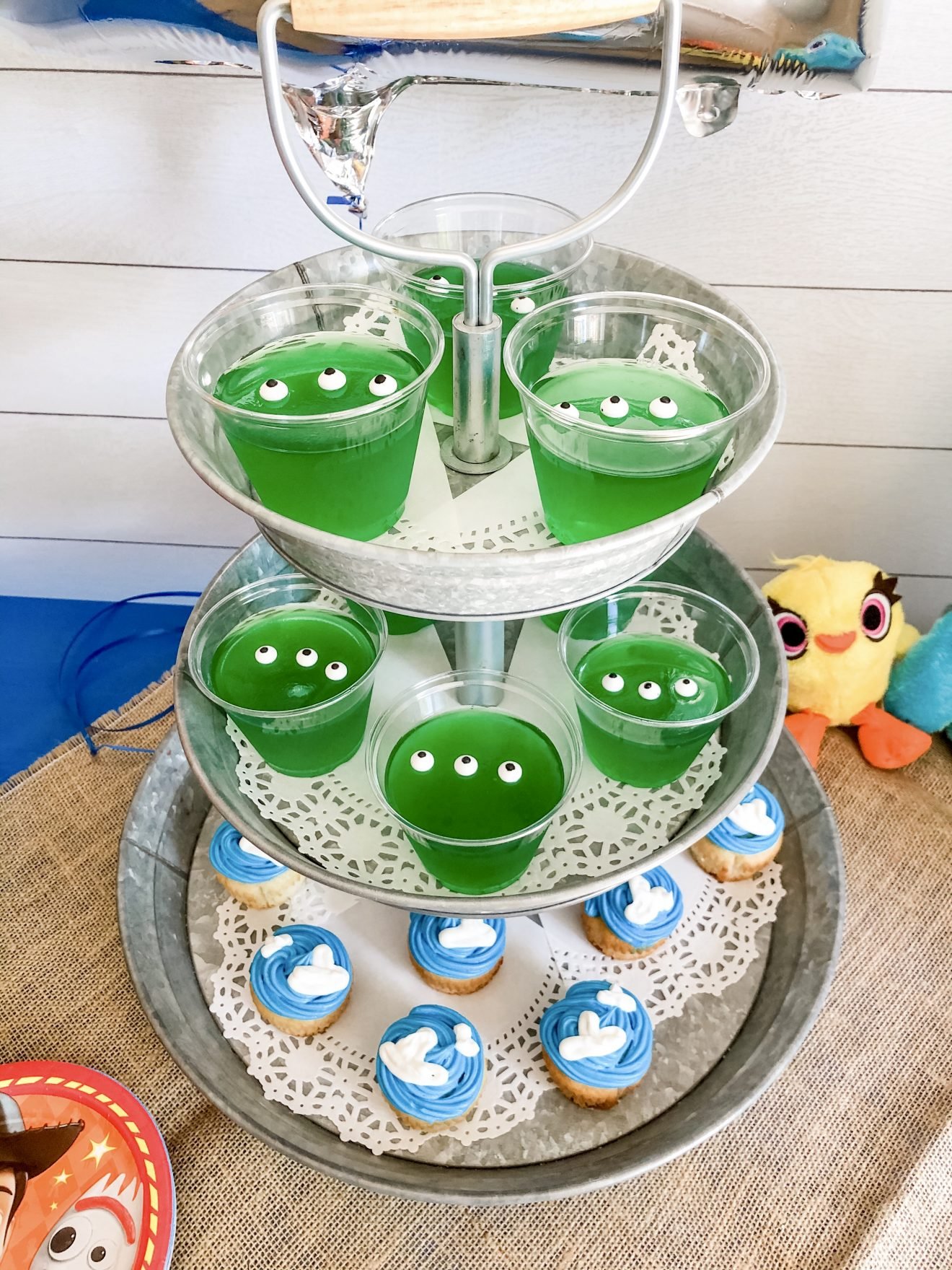 Gelatina verde e cupcakes em uma bandeja para uma festa de aniversário de Toy Story
