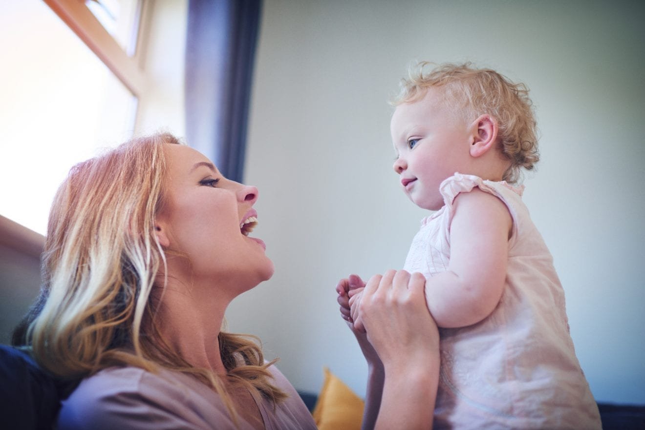 Shot of an adorable baby girl bonding with her mother at home