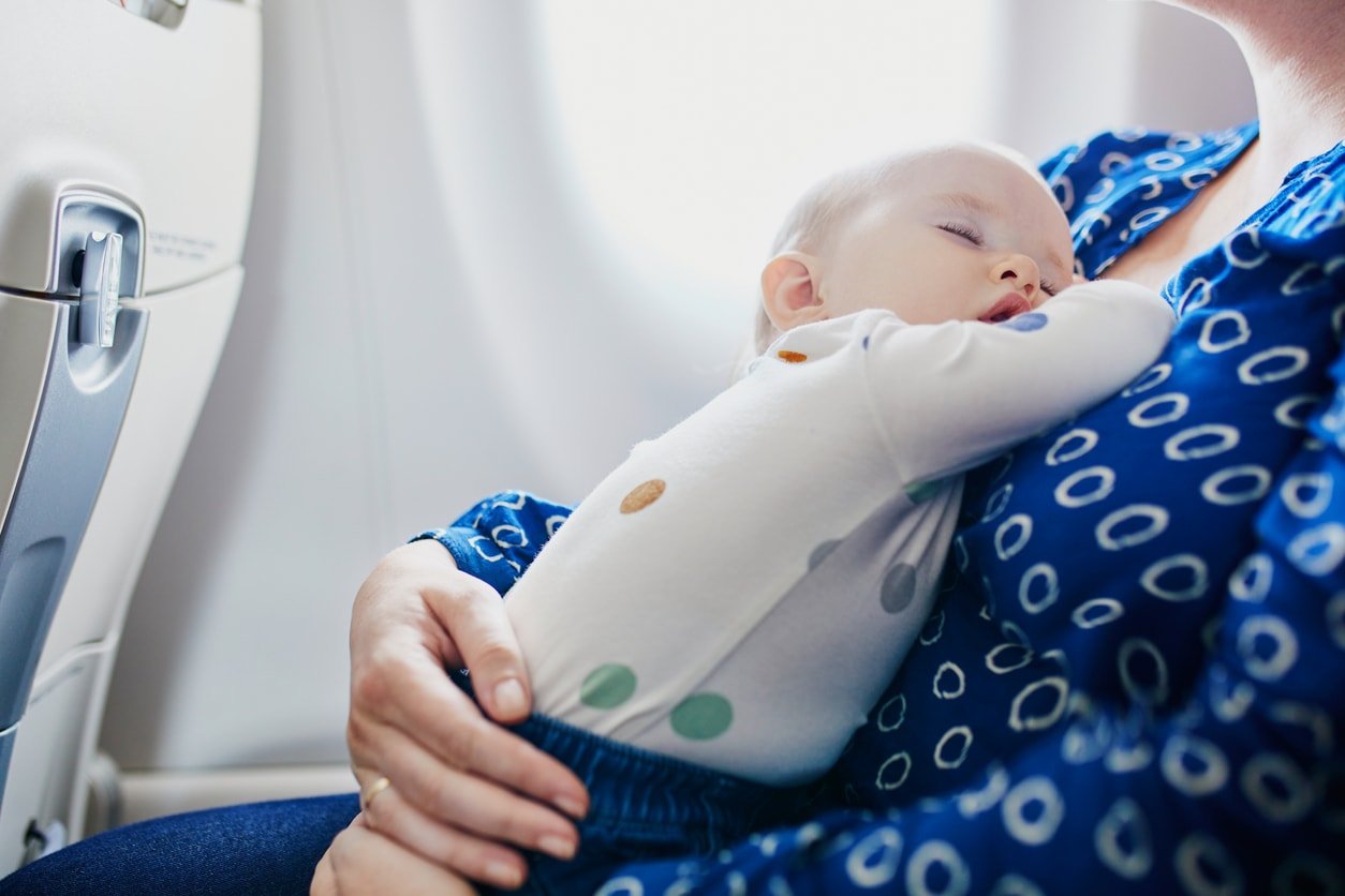 A baby is sleeping in a person